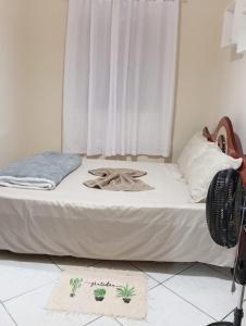 a bedroom with a bed with a fan on it at Casa do Mandacaru in Bom Jesus da Lapa