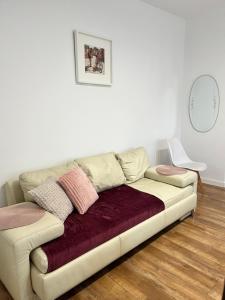 a white couch with pillows on it in a living room at AT Apartament in Pasłęk