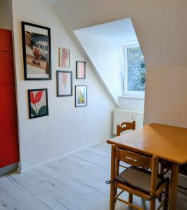 a dining room with a table and pictures on a wall at Crew Base Zeltweg in Zeltweg