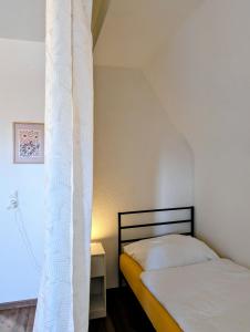 a bedroom with two beds and a white curtain at Crew Base Zeltweg in Zeltweg +7 photos