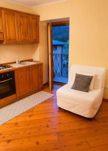 a kitchen with a white couch in a kitchen with a window at casa zanna bianca in Vione +2 photos