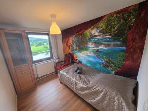 a bedroom with a river mural on the wall at Haus an der Weser in Oedelsheim