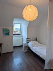 a bedroom with a bed and a large light fixture at Crew Base Zeltweg in Zeltweg