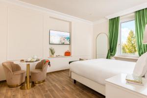 a hotel room with a bed and a table at Monastero San Pietro Claver in Rome