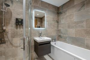 a bathroom with a tub and a sink and a shower at 2 Bed in Otterden oc-c36010 in Otterden +12 photos