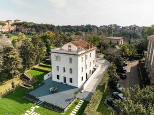 an aerial view of a white house with a swimming pool at Monastero San Pietro Claver in Rome