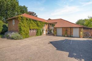 a brick house with ivy growing on it at 2 Bed in Thetford oc-57885 in Saham Toney