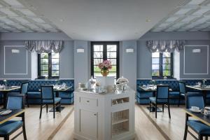 a dining room with blue chairs and tables at Monastero San Pietro Claver in Rome