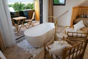 a bathroom with a bath tub and a bedroom at Namus House in Stepʼanavan +25 photos