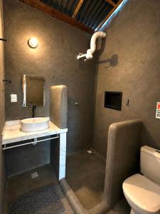a bathroom with a sink and a toilet at DuMangue Kite House in Guriú +75 photos