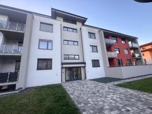 a large white building with a courtyard at Azzurro Room in Zalaegerszeg