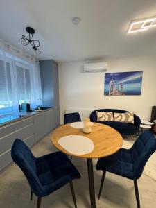 a living room with a table and chairs at Azzurro Room in Zalaegerszeg