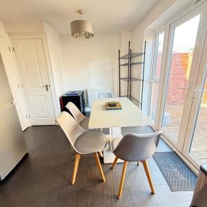 a dining room with a white table and chairs at NJ&C Properties in Bristol +11 photos
