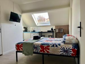 a bedroom with a bed in a room with a window at Studio relax in Villeneuve-Saint-Georges