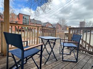two chairs and a table on a deck at Spadina Boutique Rooms in Toronto