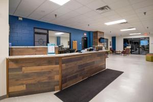 an office lobby with a wooden counter and blue walls at Massanutten Resort by TripForth in McGaheysville