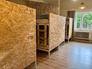 a room with four bunk beds and a window at Nómada Hostel - Surf & pilgrim House in San Vicente de la Barquera