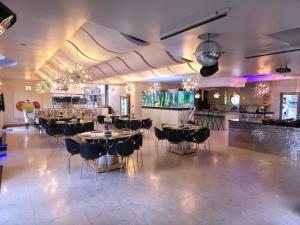 a restaurant with tables and chairs and a bar at Silva Villa in Bedfordview +49 photos