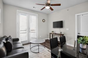 a living room with a couch and a table at Spacious 1-bedroom apartment with modern comforts in Dallas