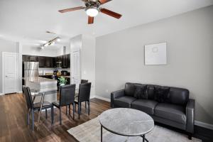 a living room with a couch and a table at Spacious 1-bedroom apartment with modern comforts in Dallas