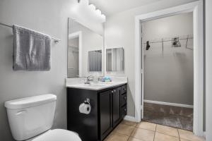 a bathroom with a toilet and a sink and a shower at Spacious 1-bedroom apartment with modern comforts in Dallas +17 photos