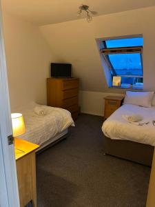 a small room with two beds and a window at EazyStay in Avonmouth