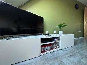 a large white entertainment center with a large flat screen tv at EazyStay in Avonmouth
