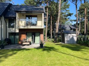 a house with a large yard with a building at Zielone Rozewie Park in Rozewie