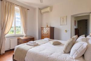 a bedroom with a large white bed and a window at Villa with Pool e Jacuzzi Free Parking AC in San Lorenzo della Costa +66 photos