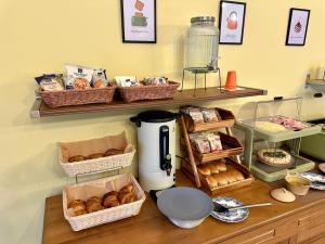 a counter with baskets of pastries and a coffee maker at Podere Cafasso Country House in Paestum