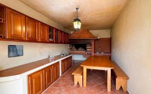 a kitchen with wooden cabinets and a wooden table at Vila Boehémia in Canhas +22 photos