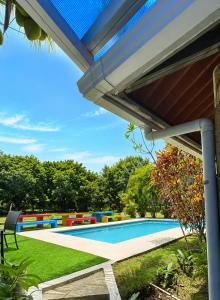 a pool in a backyard with awning and a swimming pool at Villa Edallys in Capira