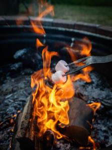 a piece of food cooking on a grill with flames at Get Away Hide Away in East Dereham