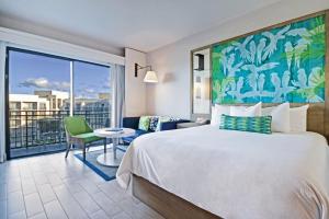 a hotel room with a bed and a balcony at Margaritaville Vacation Club - Rio Mar in Rio Grande +104 photos