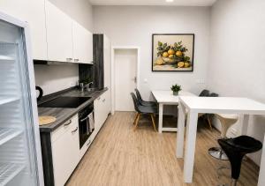a kitchen with a white table and a white dining room at Ermar Gästehaus in Baden-Baden