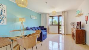 a living room with a blue couch and a table at NEW CASA BLU - Oasis Tamarindo 1 in Corralejo