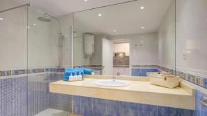 a bathroom with a sink and a large mirror at NEW CASA BLU - Oasis Tamarindo 1 in Corralejo +29 photos