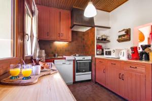a kitchen with two glasses of orange juice on a counter at Chalet Dava La Via ski in - ski out - Happy Rentals in Chamonix