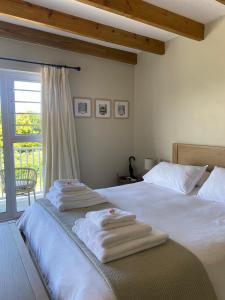 a bedroom with a bed with towels on it at 2 Bedroom sea view studio in Onrus in Hermanus