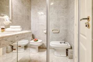a bathroom with a toilet and a sink and a shower at Victoria Palace Elegant Apt with Terrace in Menton