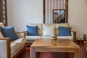 a living room with a couch and a coffee table at Don Padris Estate Bungalow in Tangalle +97 photos