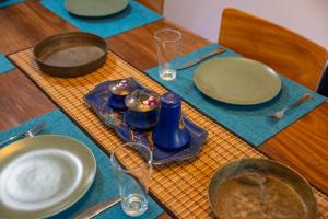 a table with plates and bowls on a blue table cloth at Don Padris Estate Bungalow in Tangalle