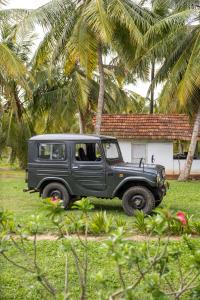 a black jeep parked in front of a house at Don Padris Estate Bungalow in Tangalle
