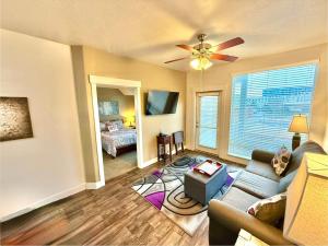 a living room with a couch and a ceiling fan at Luxury Condo in the Library Square District in Salt Lake City