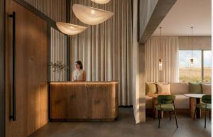 a woman standing behind a counter in a hotel room at Apart Hotel Jardín in El Calafate