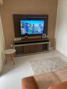 a living room with a flat screen tv at Casa em Maricá- Paraiso Itaipuaçu in Maricá