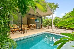 a villa with a swimming pool and a house at Selvatico Tamarindo Villas in Tamarindo