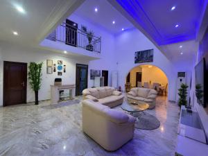 a large living room with two couches and a fireplace at Big Papa Hotel in Amasaman