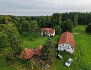 an aerial view of a house on a green field at Stawy Karłowo in Karłowo