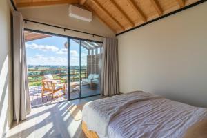 a bedroom with a bed and a balcony with a view at Eira das Maçãs - Óbidos  +78 photos